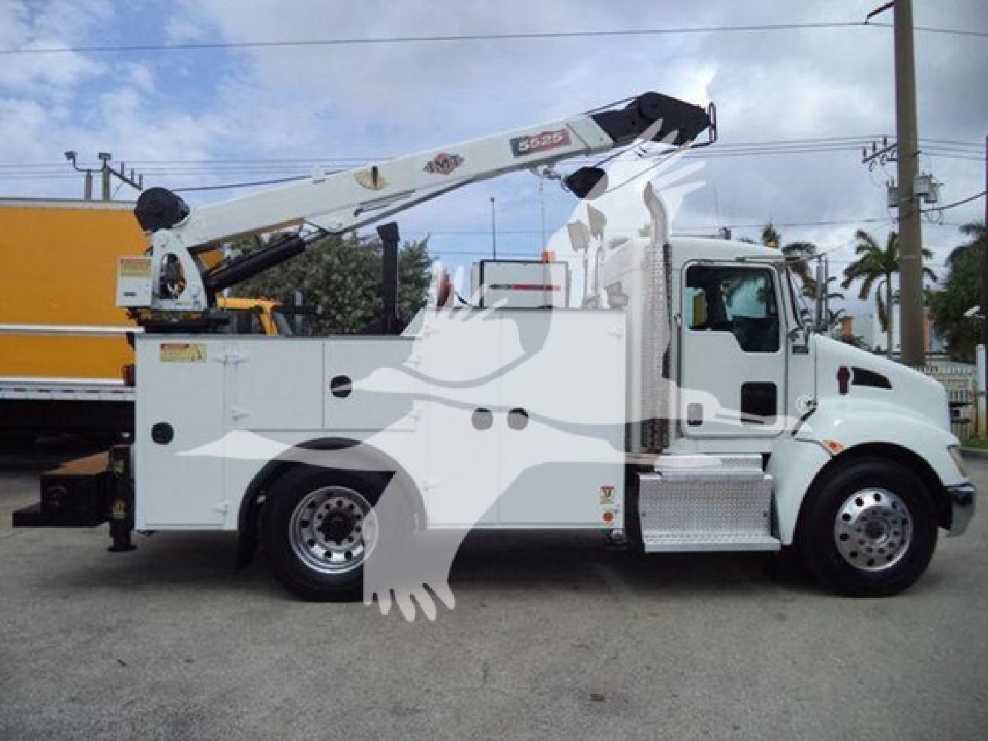 2014 Kenworth T270 service truck with crane outrigger in side view showing wheel, cab, utility compartments and crane arm