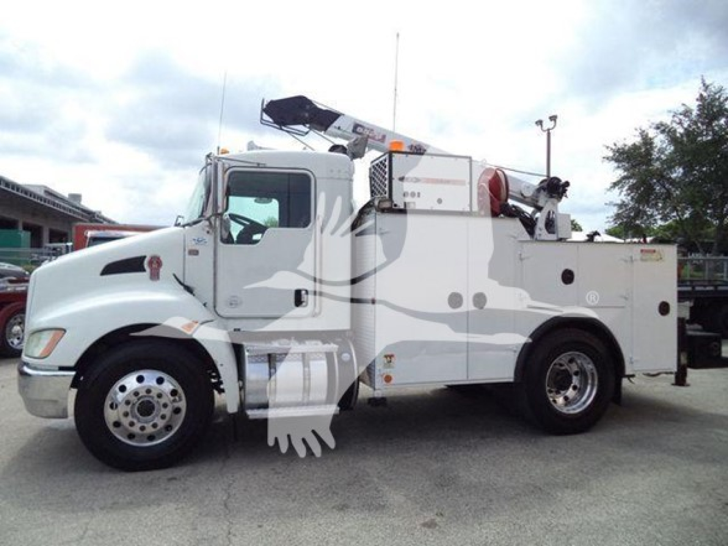 Kenworth T270 service truck side view with utility compartments and crane, white exterior, stock image.