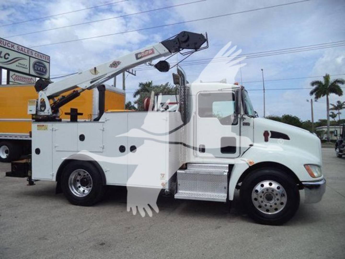 Kenworth T270 utility/service bucket truck side view showing crane on bed and white cab with chrome wheel covers.