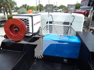 Kenworth T270 engine bay area showing blue air filter housing and winch spool with white grille and warning lights.
