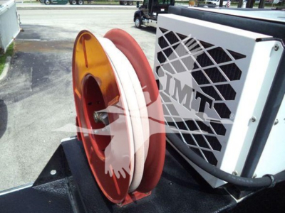 Kenworth T270 engine bay with large white coolant hose and orange pulley, side view of cooling system and A/C condenser in a service truck.