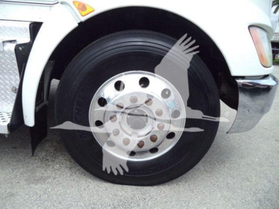 Kenworth T270 front wheel showing steel rim and tire, partial fender and bumper.