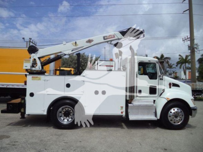 Kenworth T270 service truck side view showing boom lift and utility body with storage compartments.