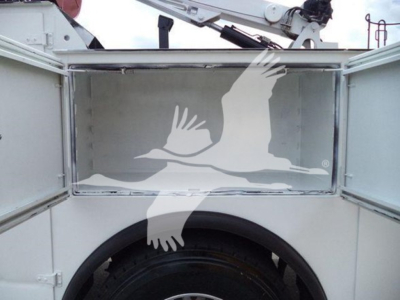 Kenworth T270 service truck cargo area with open compartments and crane arm visible, reflective interior surface.