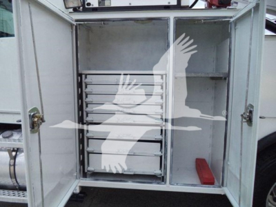 Kenworth T270 service truck rear cabinet with multiple drawers and metal shelving, open doors showing organized tool drawers and a red tool tray.