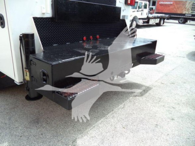Kenworth T270 service truck rear shows a black metal toolbox with steps and a diamond plate platform; warning graphic overlay partially obscures.
