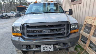 Ford F-550 front view showing bumper, grille, headlights, and Tennessee license plate 2328-GB with used condition.