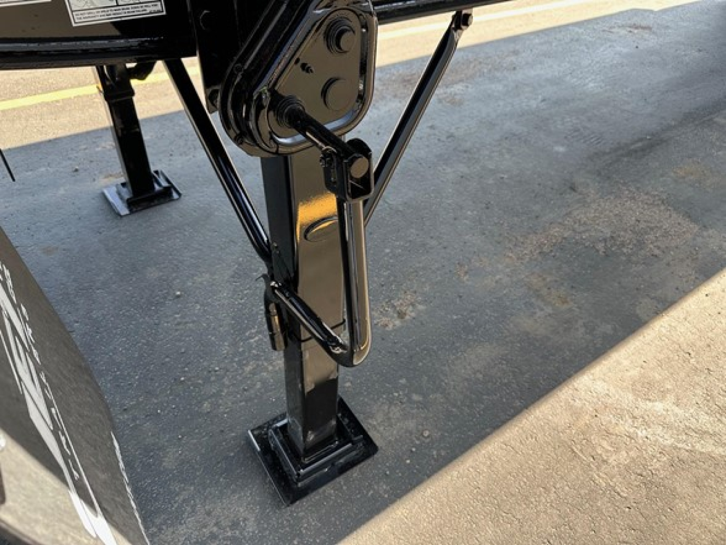 Jet Tandem Air Ride Side Dump trailer hitch/leg stand with hydraulic linkages and mounting pad visible.