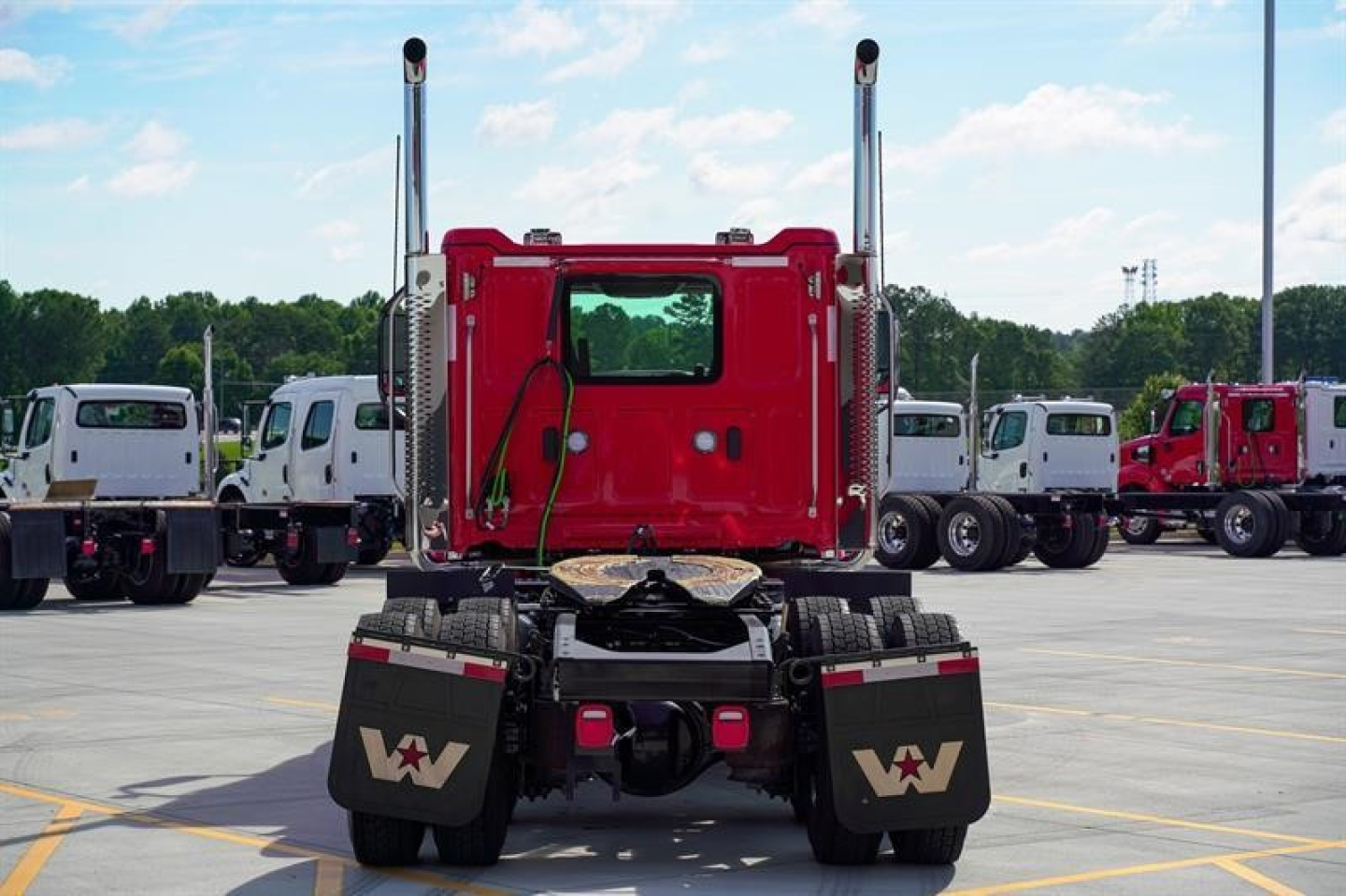 Western Star 49X rear view showing twin exhaust stacks and red cab in a truck lot