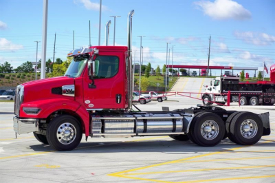Tractor unit side view showing a red Western Star 49X cab with chrome exhaust stacks, fuel tanks, and dual rear axles.