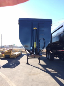 Dump trailer front view with hydraulic cylinder and hitch, blue paint, stock trailer for CPS scrap trailer.