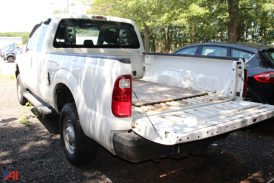 Ford F-250 Super Duty tailgate down showing flatbed in-service pickup truck.