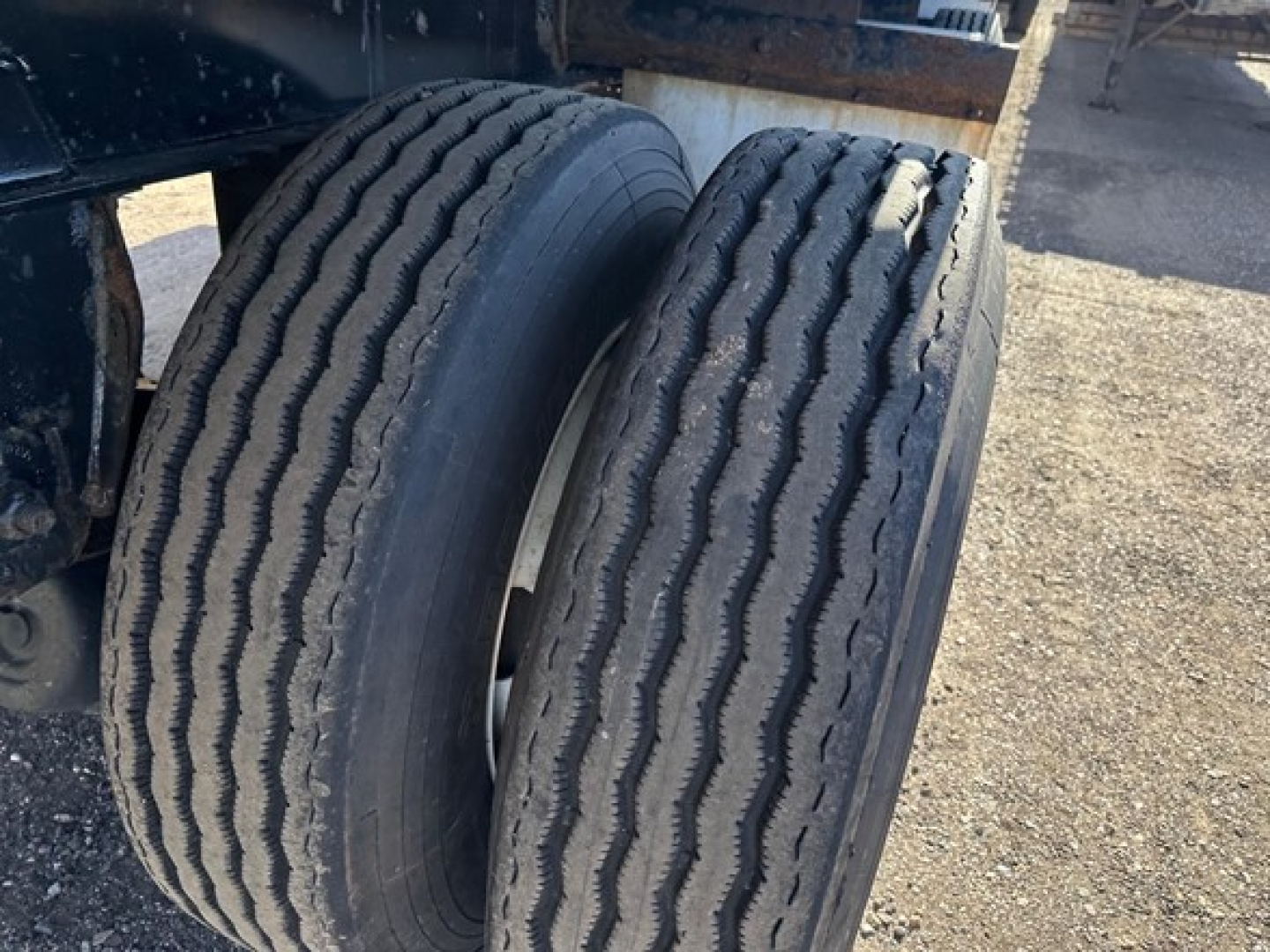 Two rear tires of a Fontaine Infinity trailer showing tread pattern and wheel rims.