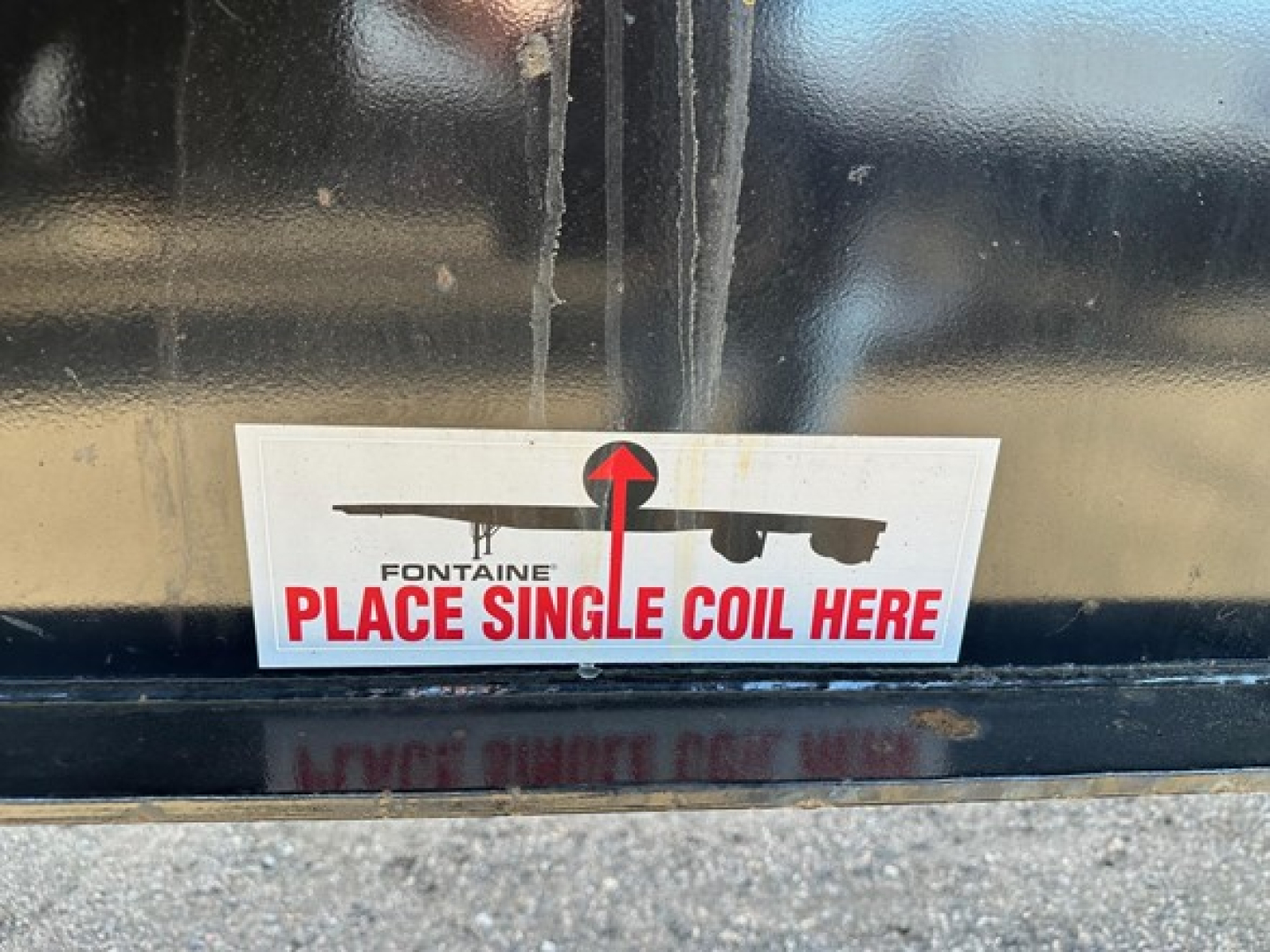 Trailer hitch area showing sticker reading ‘PLACE SINGLE COIL HERE’ with Fontaine logo and black paint.