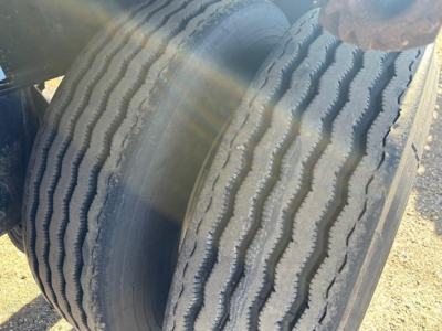 Trailer tire tread close-up showing dual tires on a Fontaine Infinity flatbed trailer.