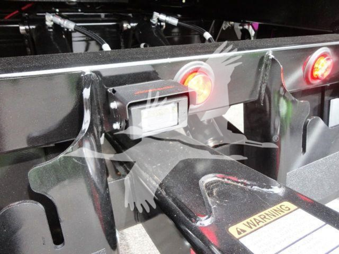 Peterbilt 337 rollback equipment hitch area showing rear frame, lights, and warning label