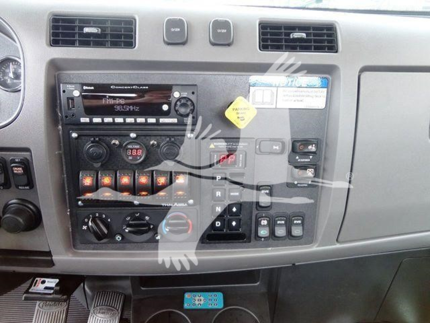 Peterbilt 337 dash view showing radio, climate controls, and gear selector panel.