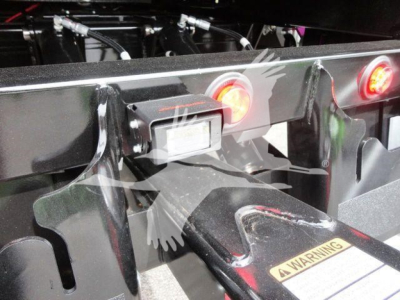 Peterbilt 337 rollback equipment hitch area showing rear frame, lights, and warning label