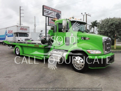 Peterbilt 337 rollback truck in green with Kong hopper on loader bed and SOLD overlay watermark.