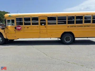 Yellow school bus with Central School District signage and stop sign, side view showing multiple windows and a black tire.
