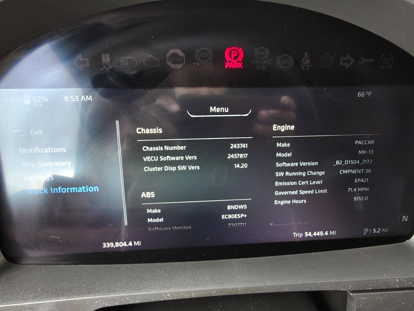 Kenworth T680 instrument cluster display showing vehicle information including chassis number, software versions, engine hours, and ABS data.