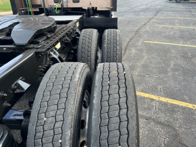 Kenworth T680 truck chassis with dual rear axles and tires in view; part of the frame and fifth wheel visible; no text readable