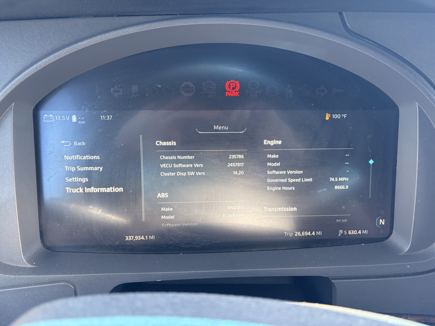 Kenworth T680 dashboard display showing chassis and engine information screen with VIN and trip data.