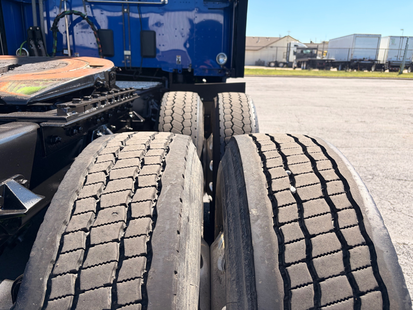 Kenworth T680 tractor rear axles and dual tires, view of 4 rear wheels with tread.