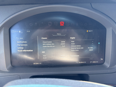 Kenworth T680 dashboard display showing chassis and engine information screen with VIN and trip data.