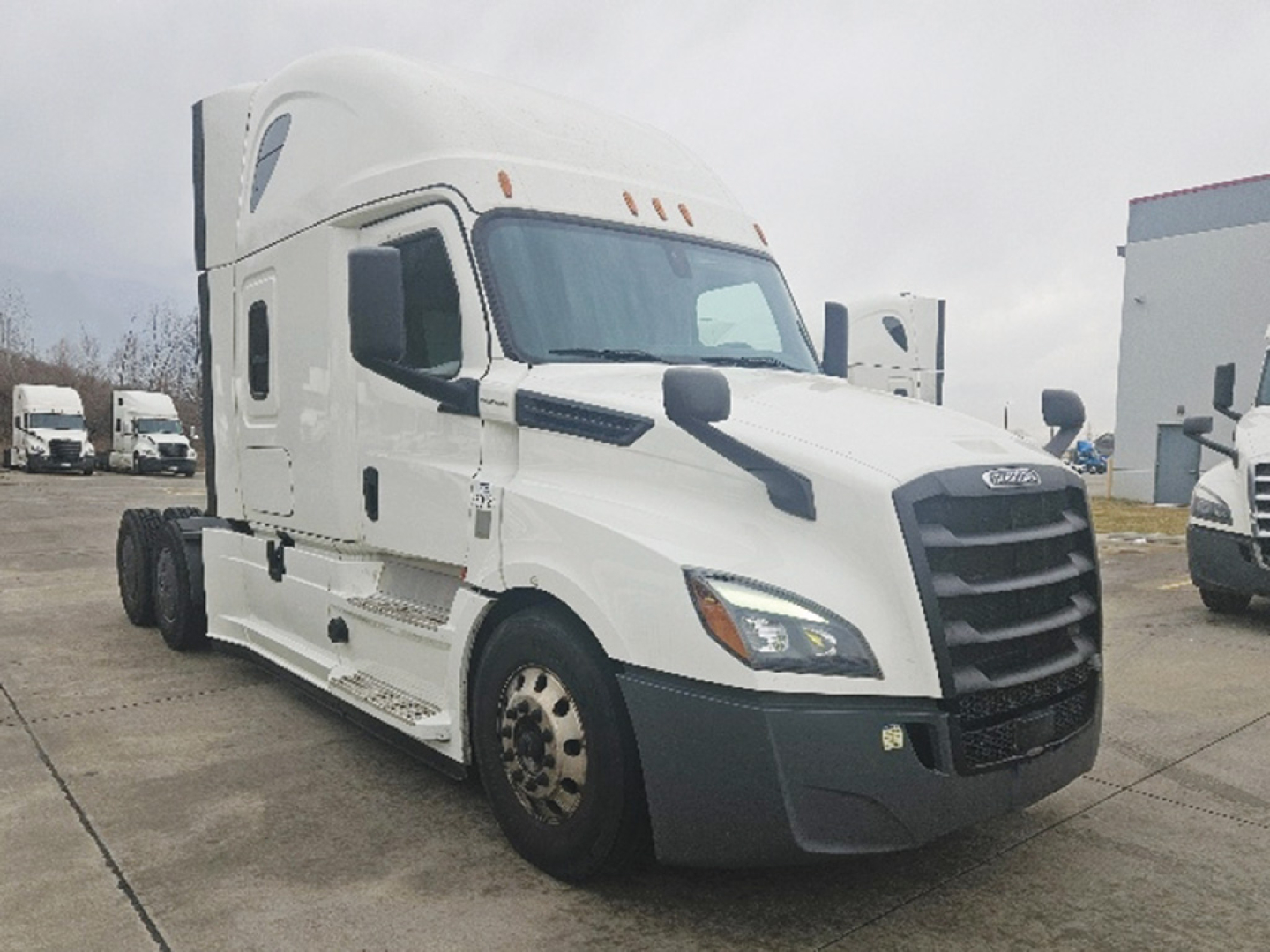 Truck cab front-left view of a white 2020 Freightliner Cascadia126 sleeper cab with large grille and dual mirrors.