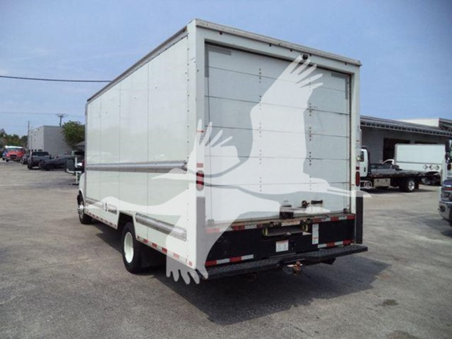 Rear view of a used 2021 GMC G3500 box truck with white cargo box and twin rear doors.