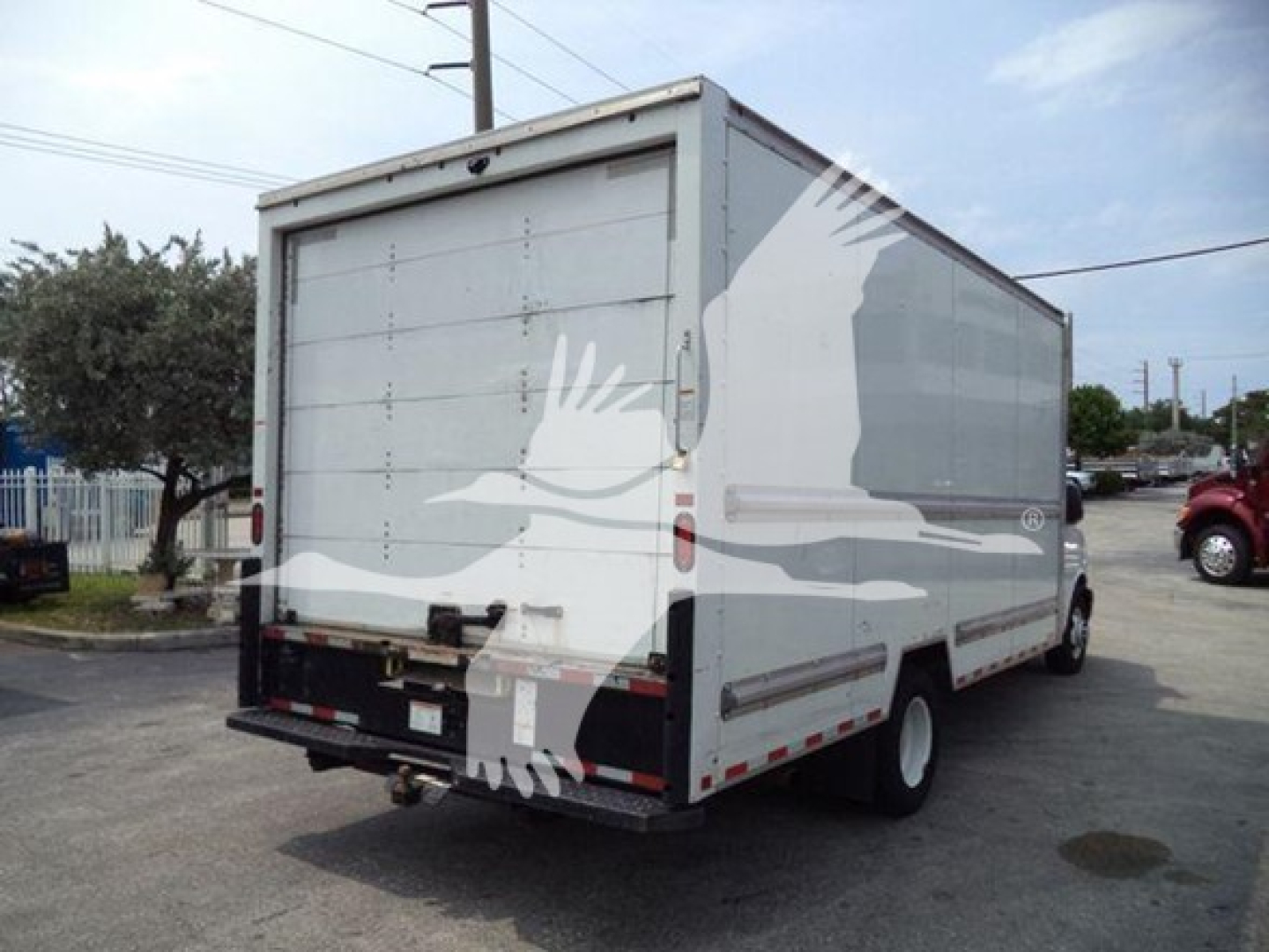 GM C3500 box truck rear view showing cargo area, taillights, bumper, and rear doors.