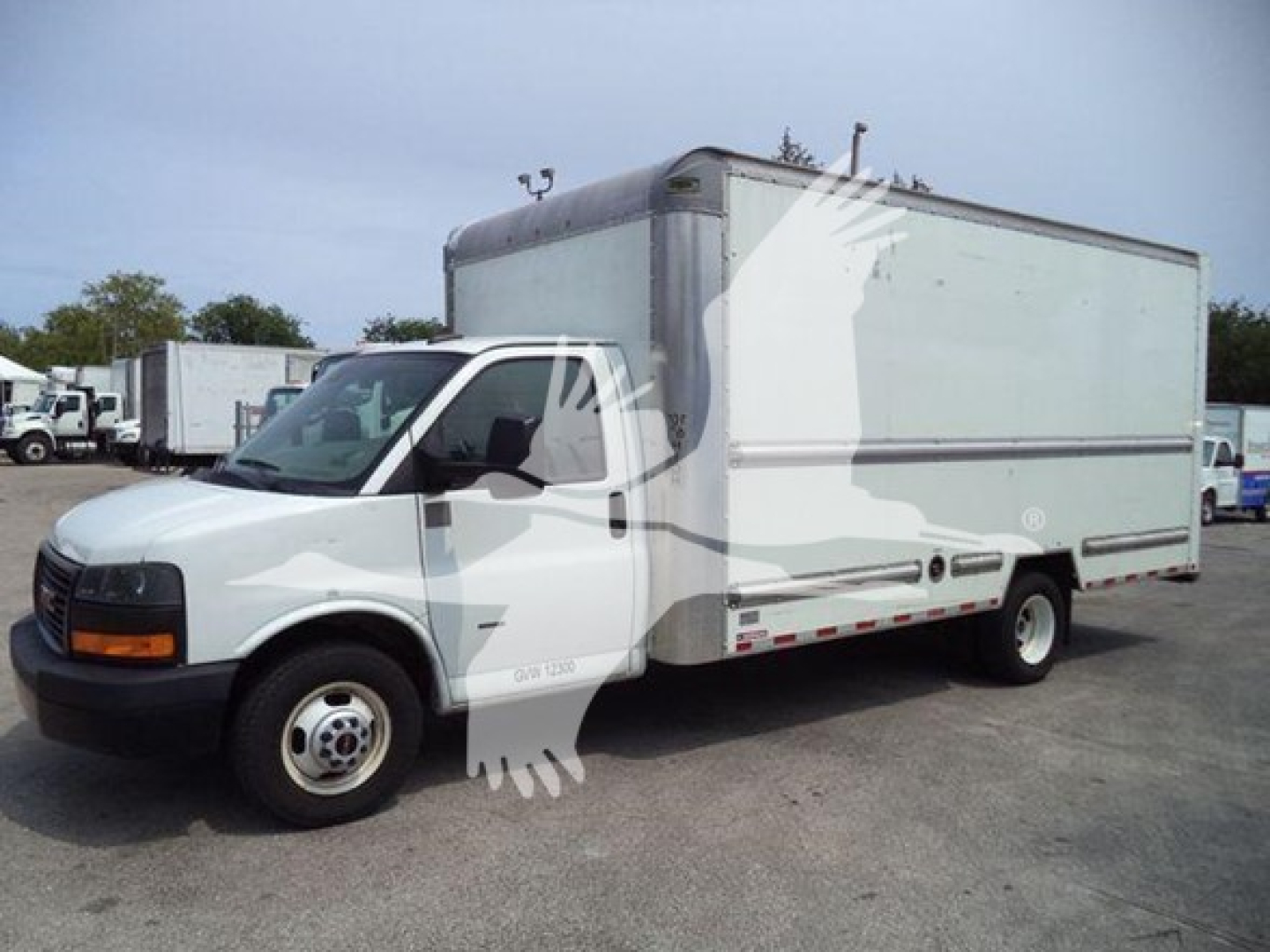 GMC G3500 box truck side view with cargo box, white cab, 2021 model year? visible stock number and VIN not legible on image.
