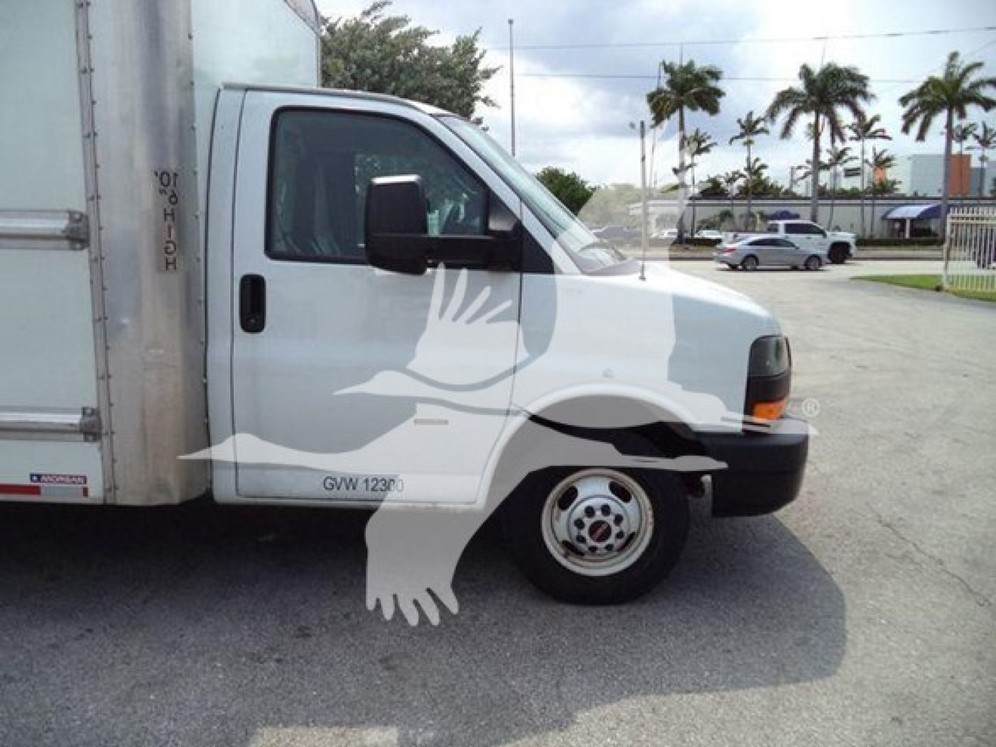 GMC G3500 box truck cab front-right view with a large ghost watermark image overlay; visible text on the door reads GVW 1230 (likely GVW 1230).