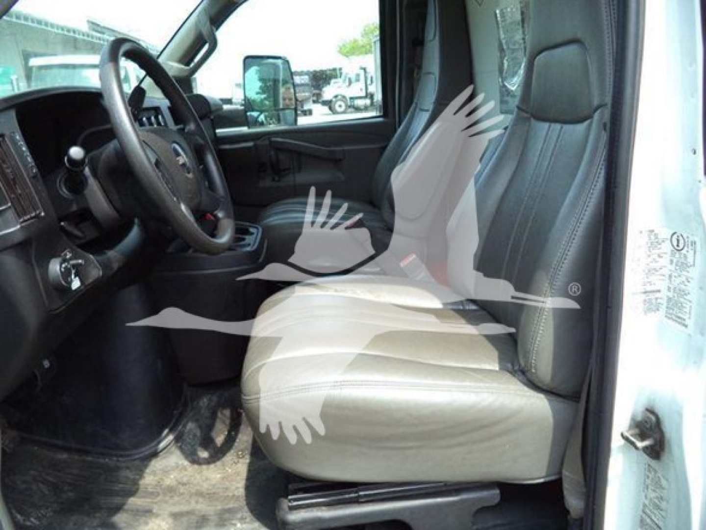 GMC G3500 cab interior showing beige cloth driver and passenger seats, steering wheel, dashboard, and front door. Visible VIN/info in listing.