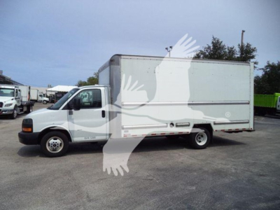 2021 GMC G3500 box truck side view with cab in front and large cargo box, VIN tag and stock number in listing context.