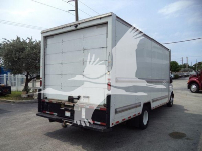 GM C3500 box truck rear view showing cargo area, taillights, bumper, and rear doors.