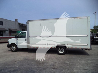 GMC G3500 box truck side view showing cargo box and front cab with stock number T10245