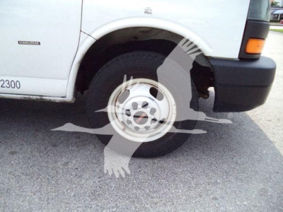 Truck wheel close-up on a 2021 GMC G3500 listing showing front left wheel and fender with body tag and side badge
