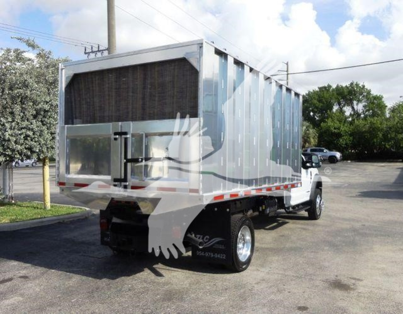 Ford F-550 dump truck rear-side view showing aluminum dump bed and chassis with HVAC front cab.
