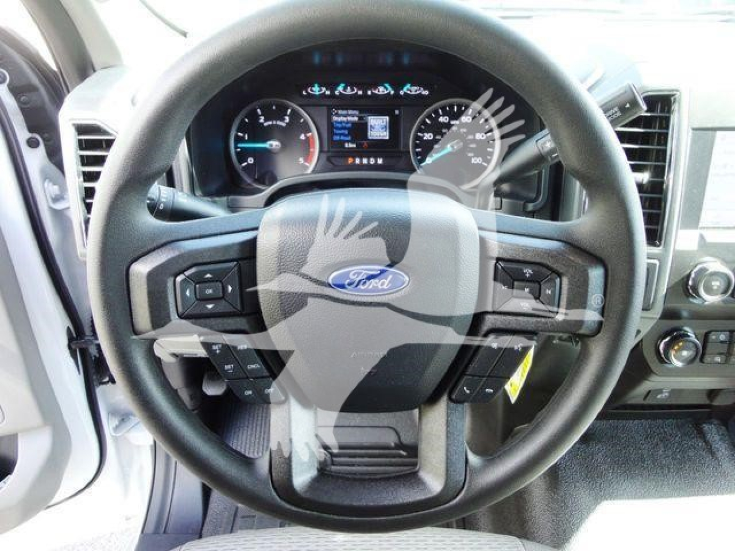 Ford F-550 interior steering wheel and dashboard showing Ford emblem and instrument cluster.