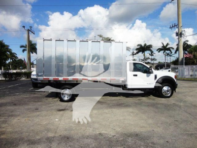 Truck bed view of a white 2022 Ford F550 dump truck with a silver metal cargo body and dual rear wheels, side profile visible.