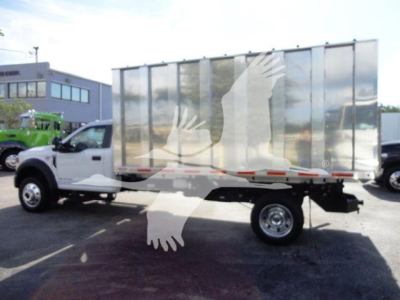 Ford F550 dump truck with chrome dump body, side view showing chassis and single rear wheel.