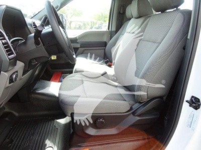 Ford F-550 cab interior with front seats and steering wheel; gray cloth seats, dashboard, and door frame visible.