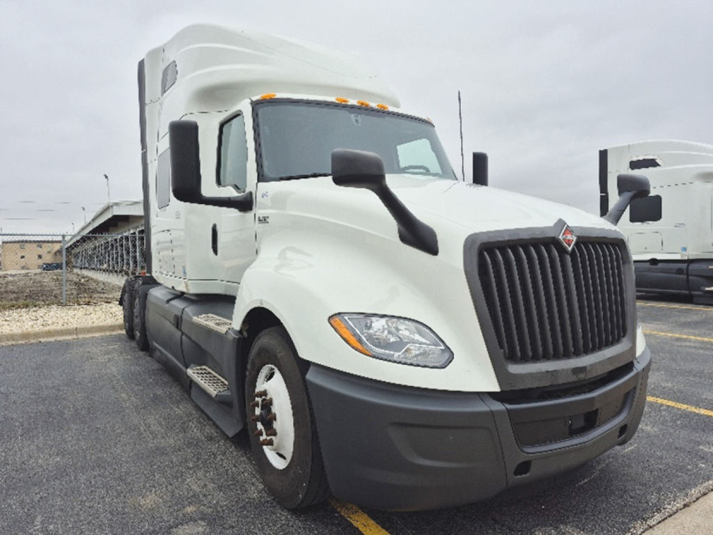Truck cab showing 2023 International LT625 with white exterior and black grille, day cab side view, VIN 3HSDZAPR3PN728955 not visible text on image