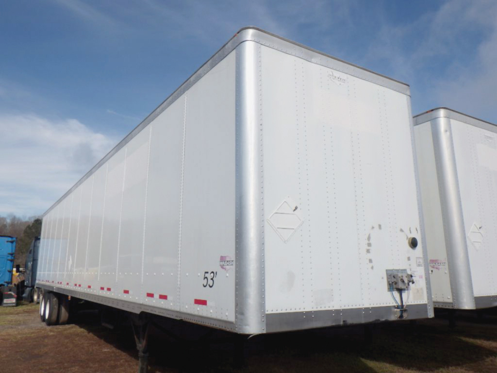 Trailer side profile showing a 53' gray Wabash DuraPlate van trailer with white reflective striping and rear doors.