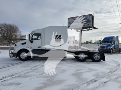 Peterbilt 579 conventional sleeper tractor in side profile, white paint, on snow, stock number 2203074-B, VIN 1XPBDP9X0KD643710.
