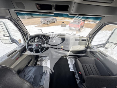 Peterbilt 579 truck cab interior view from driver seat, dashboard and steering wheel visible.