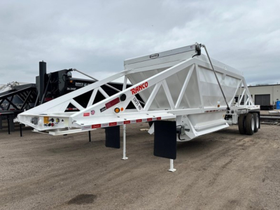 Ranco LW21-40 dump trailer on landing gear with white steel frame, dual axles, and triangular truss design; visible brand name 'RANCO' on side and reflective tape along sides.