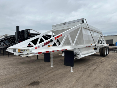 Ranco LW21-40 dump trailer on a dirt lot, white rectangular body with lattice frame, dual rear axles, landing gear, and red RANCO logo visible on side.